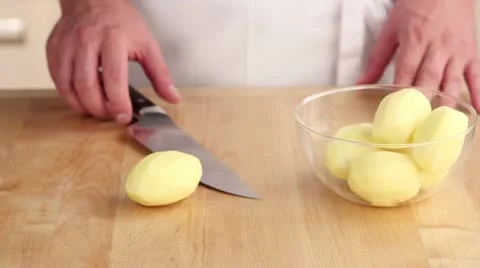 Peeled potatoes being quartered Video stock 24671471