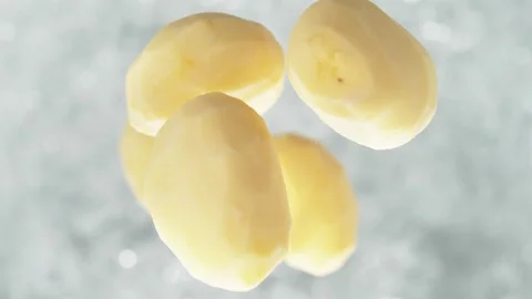 Peeled Potatoes Falling into Pot of Boiling Water Stock Footage 271397511
