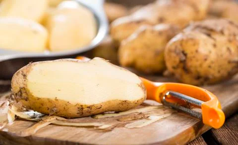 Peeled potatoes Stock Photos