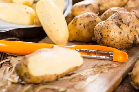 Peeled potatoes Stock Photos