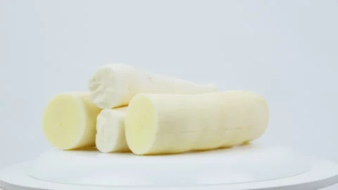 Peeled Raw Cassava Root Rotating on White Background Stock Footage 324912565