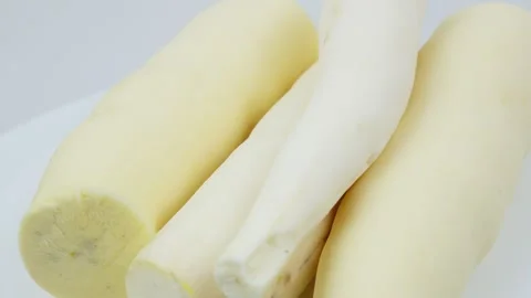 Peeled Raw Cassava Root Rotating on White Background Stock Footage 324912704