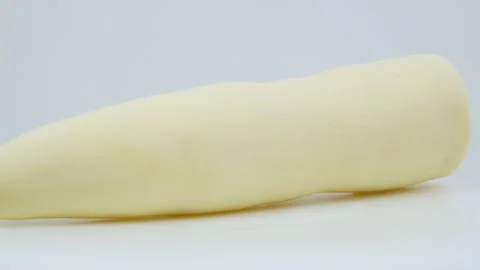 Peeled Raw Cassava Root Rotating on White Background Stock Footage 324914549