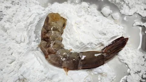 Peeled Raw Prawn Being Dusted with White Flour for Deep Frying Stock Photos