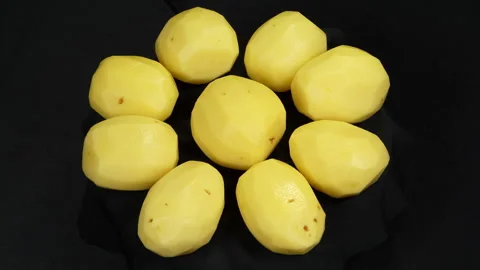 Peeled Raw Yellow Potatoes Rotating on Black Background Stock-Footage 343592777