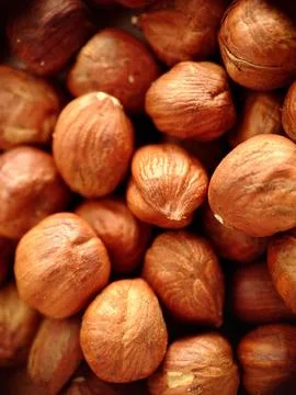 Peeled from the shell a handful of hazelnuts close-up Stock Photos