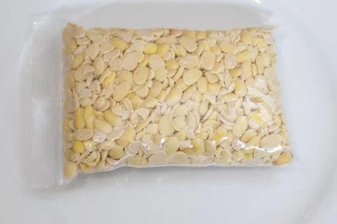 Peeled split soybeans packed tightly in a clear plastic zipper pouch, prese.. Stock Photos