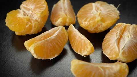 Peeled tangerines on a dark background Video stock 198233295