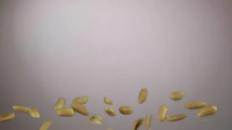 Peeled tasty peanuts are bouncing on a white background Stock Footage 134968421