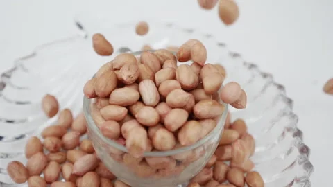 Peeled tasty peanuts are bouncing in Galss Stock Footage 139746678