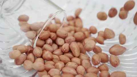 Peeled tasty peanuts are bouncing in Galss Stock Footage 139746729