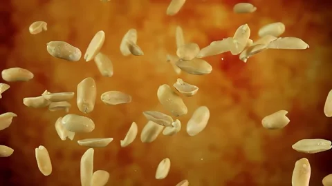 Peeled tasty peanuts are bouncing on a yellow ochre background Stock Footage 296132885