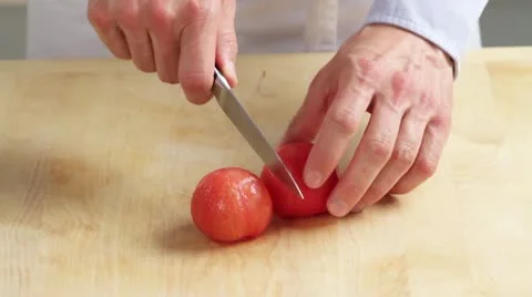 The peeled tomatoes being quartered Video stock 24673194
