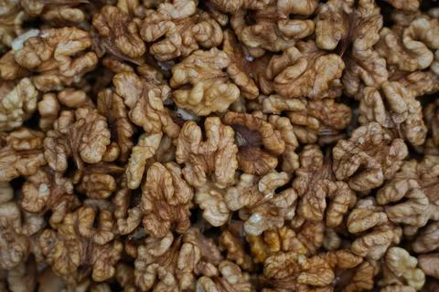Peeled wallnuts texture. Full frame of peeled raw organic walnuts in the mark Stock Photos