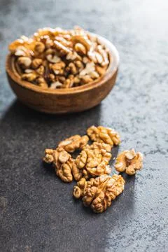 Peeled walnut kernels on black table. Stock Photos