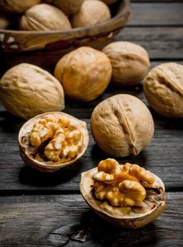 Peeled walnut on wooden background. Stock Photos