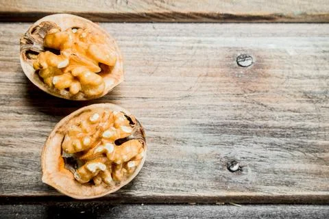 Peeled walnut on wooden board . Stock Photos
