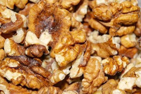 Peeled walnuts close-up. Surface texture. Healthy diet. Stock Photos