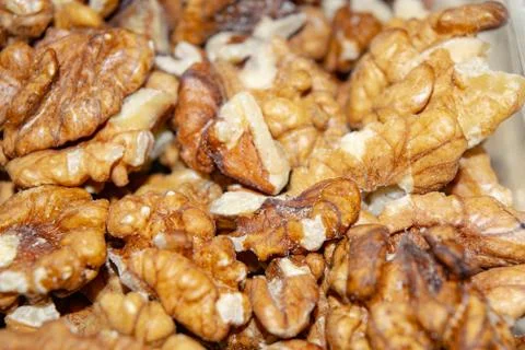 Peeled walnuts close-up. Surface texture. Healthy diet. Stock Photos