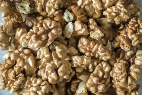 Peeled walnuts stacked in large quantity. Stock Photos