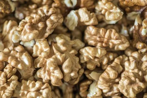 Peeled walnuts stacked in large quantity Stock Photos