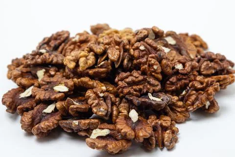 Peeled walnuts on a white background. A bunch of shelled walnuts. Stock Photos