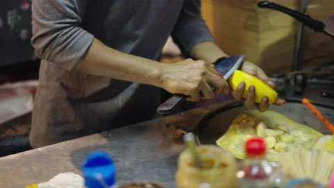 Peeling and cutting a mango and putting it into a crepe Stock Footage 234979569