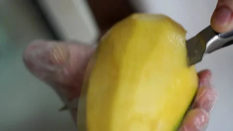 Peeling and slicing Fresh Mango for Mango sticky rice 스톡 동영상 238501485