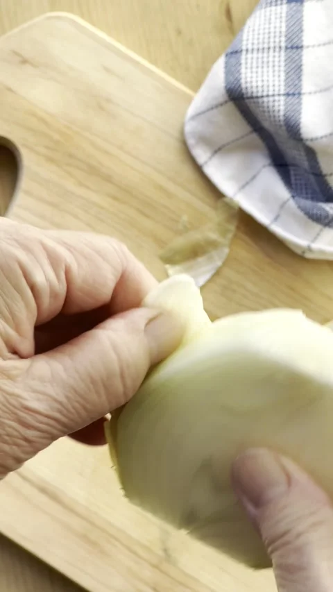 Peeling and slicing an onion vertical Stock Footage 220794847