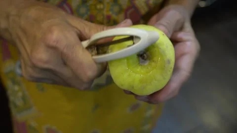 Peeling an apple with hands by an elderly lady Stock Footage 272753223