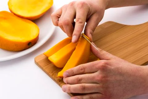Peeling away the mango skin from a fruit chip Stock Photos