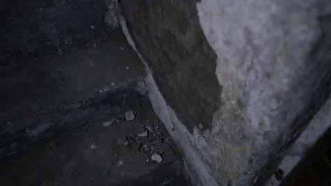 Peeling basement wall in the dark close-up. Old abandoned hideout underground Stock Footage 235187968
