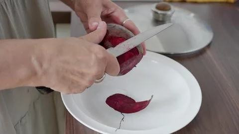 Peeling beet delicately, crafting rustic beet salad with care, slowmotion Stock Footage 322809620