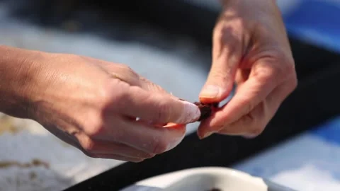 Peeling black olives with both hands Video stock 133749002