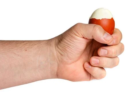 Peeling Boiled Egg in Hand 库存照片