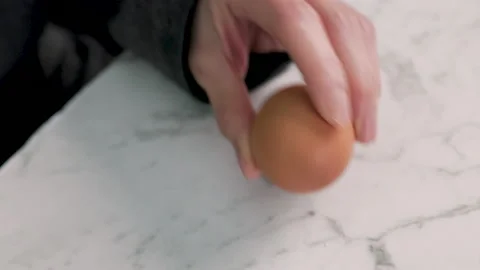 Peeling boiled egg over marble benchtop Video stock 169155508