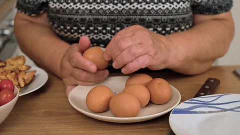 Peeling boiled egg for preparing Caesar salad. Removing shell from cooked egg Stock Footage 333241519