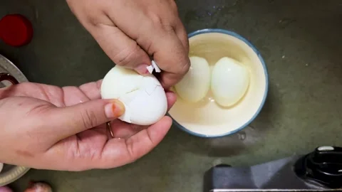 Peeling Boiled Eggs By Hand For Homemade Egg Curry Preparation In Kitchen Stock Footage 340955907