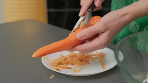 Peeling Carrot on Kitchen Counter Cooking Scene Video stock 341423037