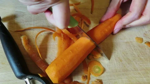 Peeling carrot. preparing food. Stock Footage 247050889