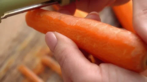Peeling Carrot with Vegetable Peeler. Stock Footage 255664246