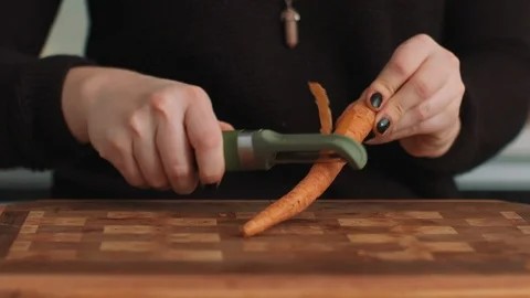 Peeling Carrots on a Cutting Board Stock Footage 86161950