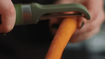 Peeling Carrots on a Cutting Board Stock Footage 86161956