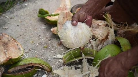 Peeling coconut with knife Stock Footage 167594490
