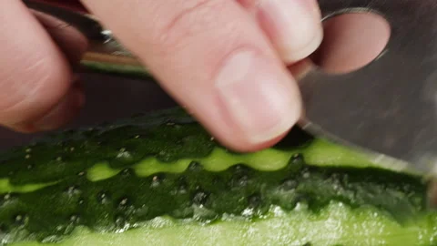 Peeling cucumber with grater close-up. Preparing some vegetables for cooking Stock Footage 260417069