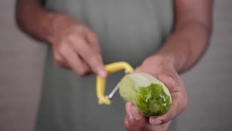 Peeling a cucumber in the kitchen Stock Footage 343230061
