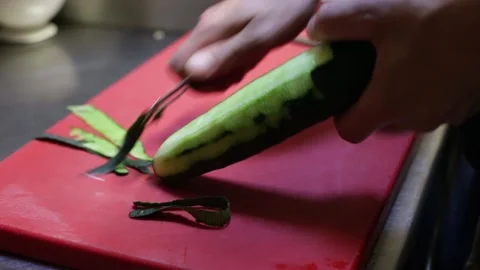 Peeling a cucumber with a peeler Stock Footage 137945803