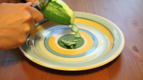 Peeling Cucumber on a Plate Stock Footage 533377