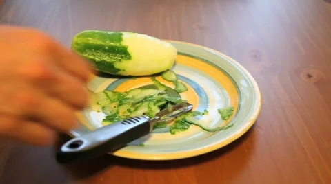 Peeling Cucumber on a Plate Stock Footage 533573