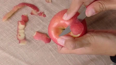 Peeling the fresh apple with the sharp knife Stock Footage 150399348
